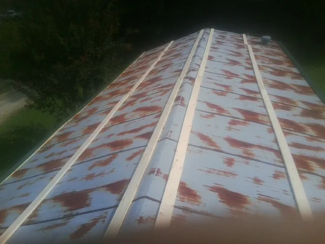 Rusted metal roof panels with new wood purlins before replacement — Storm Damage Roof Repair in Hauppauge by Roofing Brothers