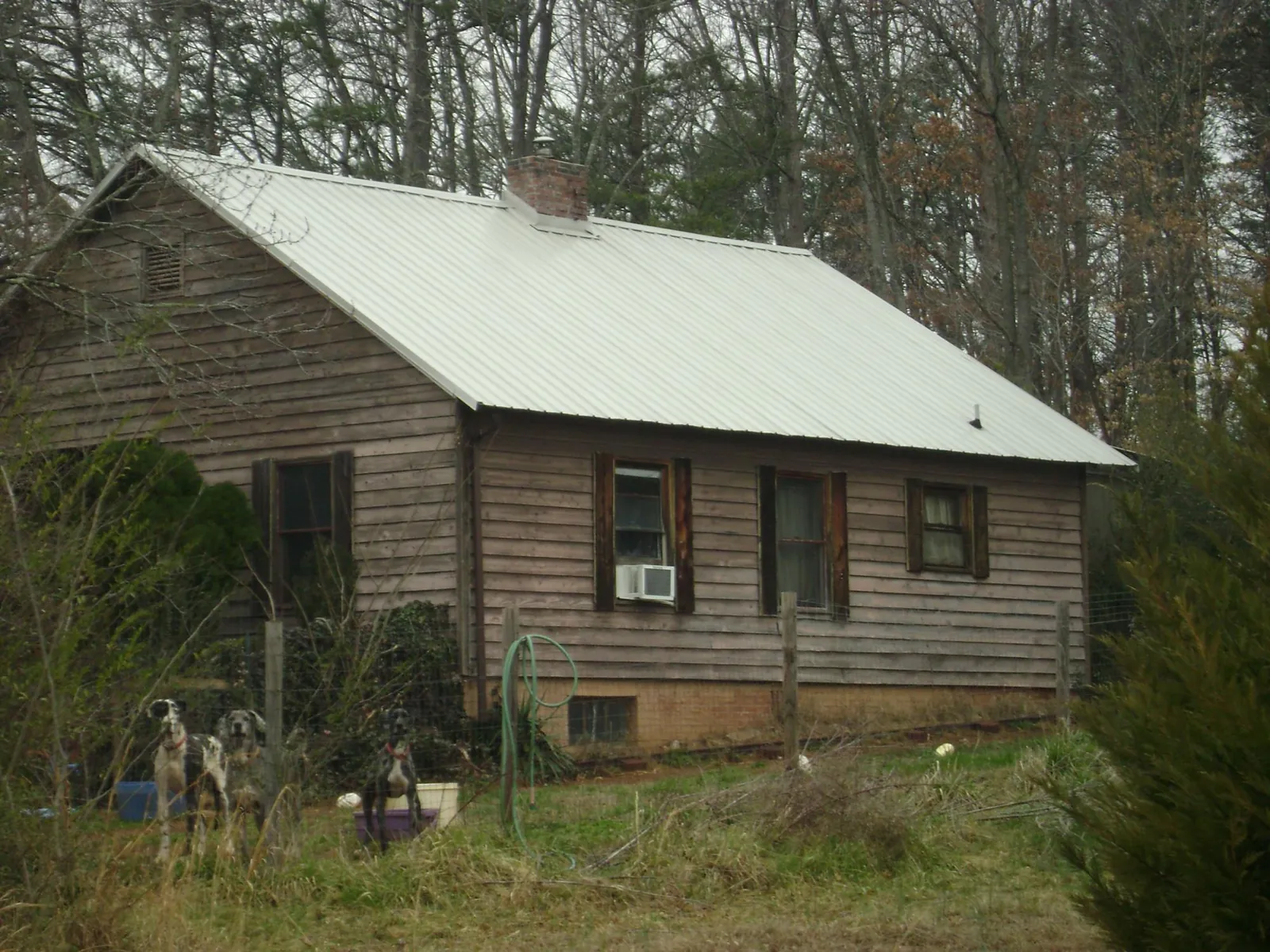 White metal roof on an old wood sided farmhouse, from a Metal Roof Installation job in Hauppauge